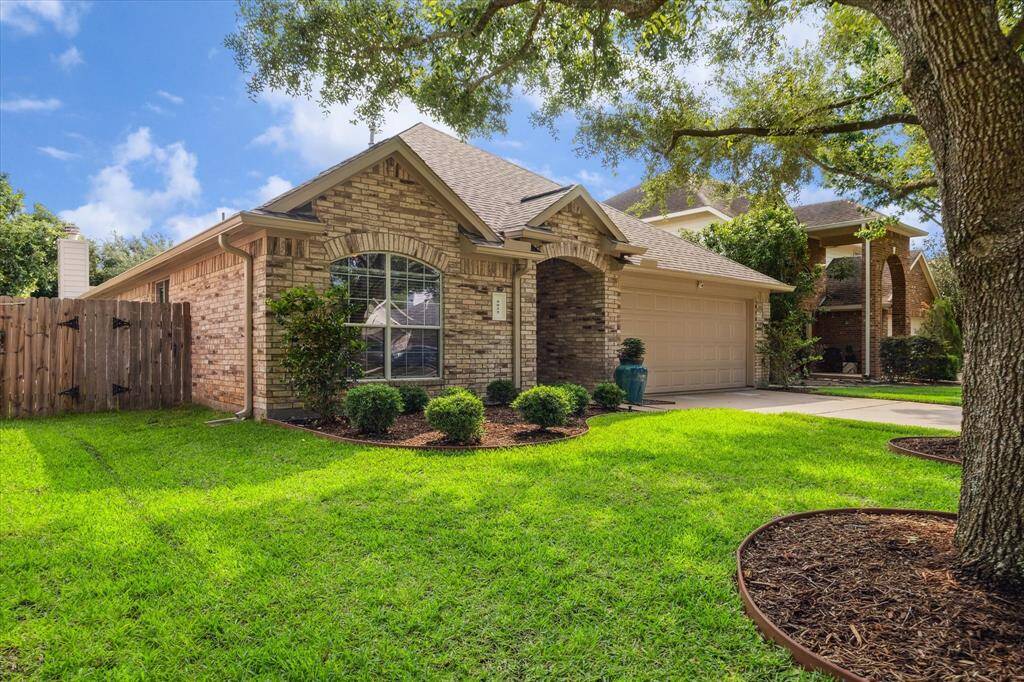 Take in this gorgeous side view highlighting the beautifully maintained landscaping and charming architectural details. With eye-catching brickwork and that perfect pop of greenery, this home is as photogenic as it is livable.