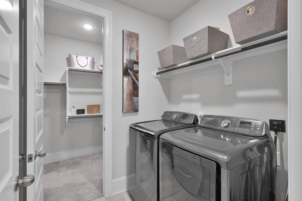 Utility room features a pass through to the primary bedroom closet making laundry as convenient as possible!