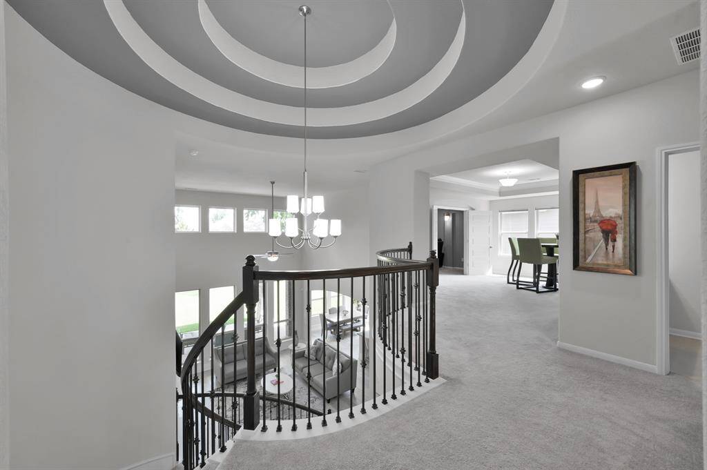 Upstairs features three secondary bedrooms, two full bathrooms (one en-suite), a game room, and media room.