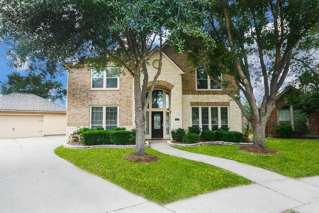 Welcome home to timeless charm and curb appeal! Nestled at the end of a peaceful cul-de-sac, this beautifully updated brick-and-stone retreat greets you with its arched entry, lush landscaping, and long driveway to a detached garage—offering space, privacy, and that ‘this is the one’ feeling the moment you arrive.