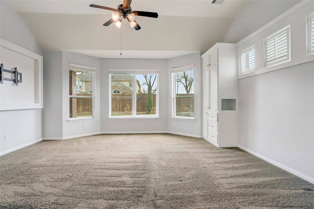 Primary bedroom with bay sitting area and built ins