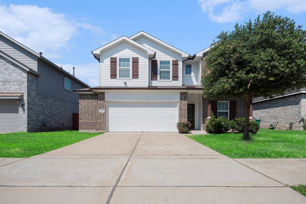 Charming two-story home with a spacious driveway, inviting facade, and well-maintained landscaping. Ideal for families seeking comfort and style.