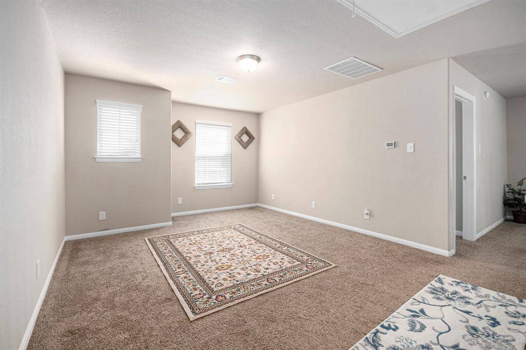 Versatile loft space, perfect for a game room or cozy retreat. Bright and inviting with ample natural light.