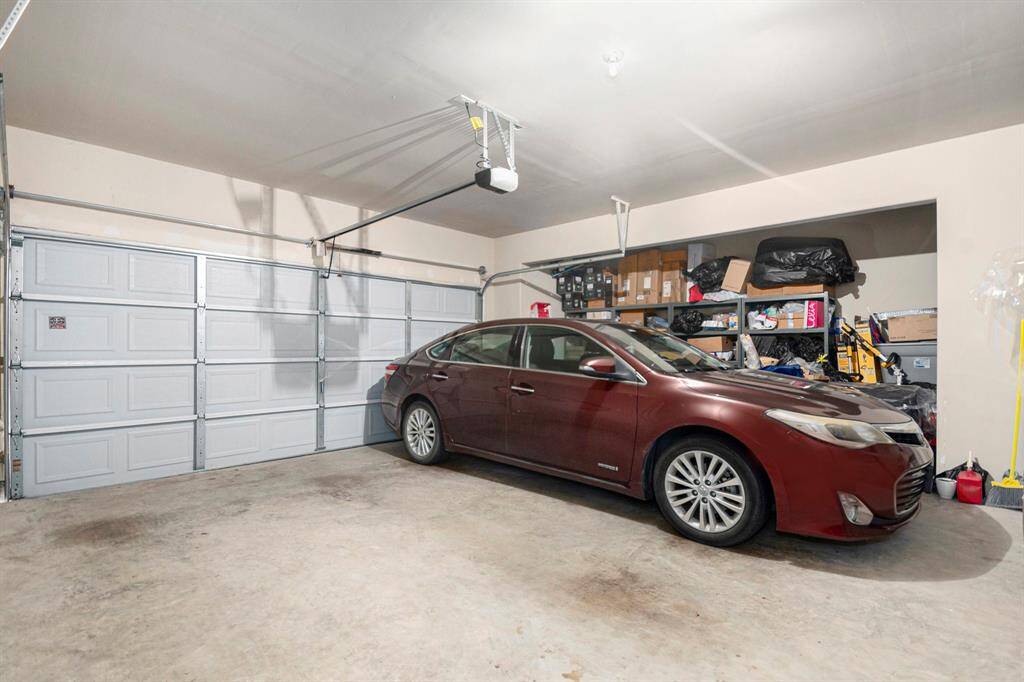 Spacious two-car garage with ample storage, perfect for vehicles and organization.