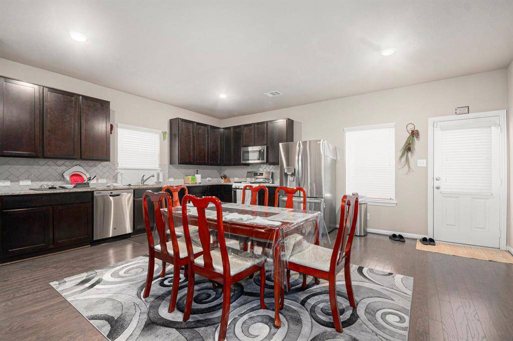 Spacious dining area seamlessly connected to a modern kitchen, perfect for entertaining and family meals.