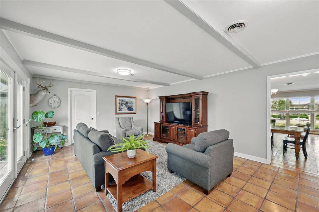 ANOTHER VIEW OF THE FAMILY ROOM WITH BEAMED CEILING.