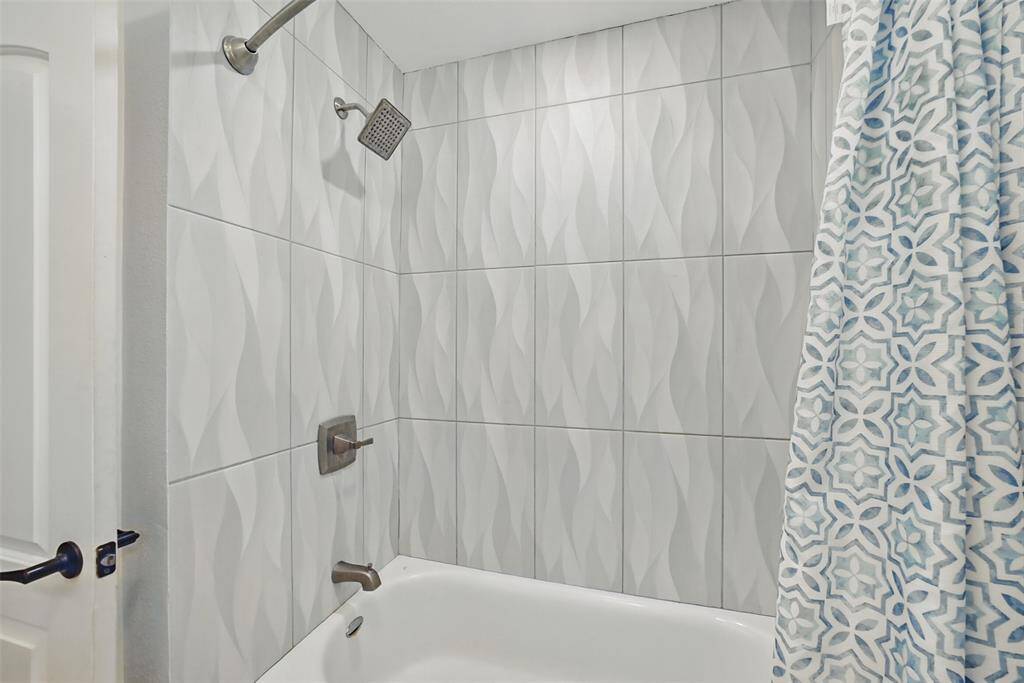 SHOWER/TUB COMBO WITH CUSTOM TILES.