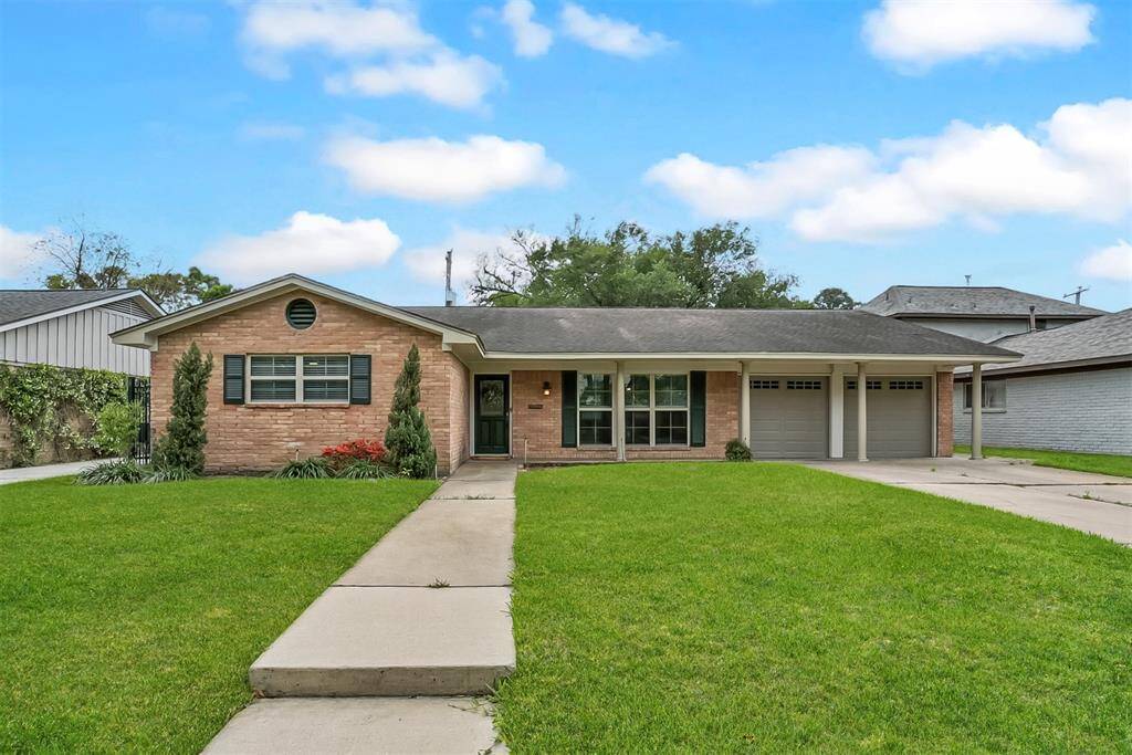 CHARMING COTTAGE STYLE 1-STORY HOME WITH GABLED ROOF AND DECORATIVE SHUTTERS.