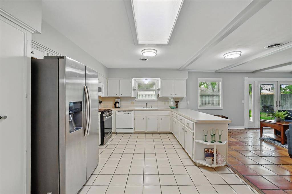 THE KITCHEN IS SPACIOUS WITH PLENTY OF CABINETS.