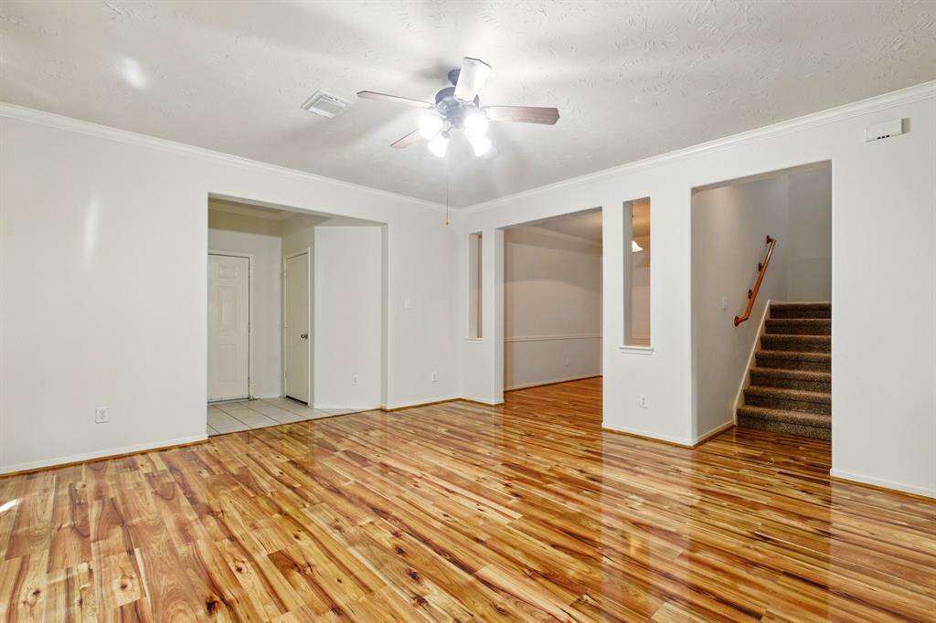 front entrance with a coat closet and the entrance to the garage, formal dining room, and stairs that has new carpet.