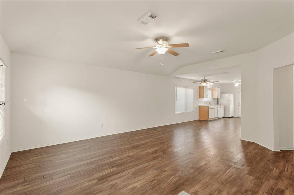 Expansive living room with luxury vinyl plank flooring in a rich color that will never go out of style.