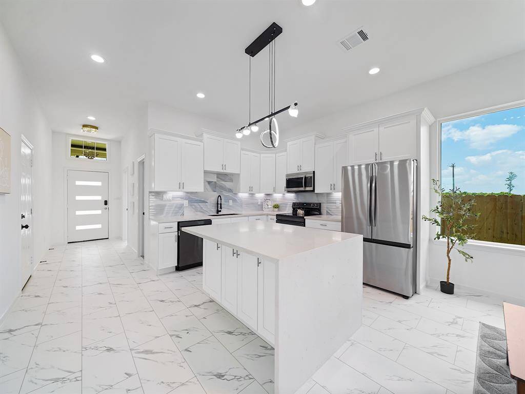 Full light front door and picture Fram windows throughout capture an abundance of natural light.