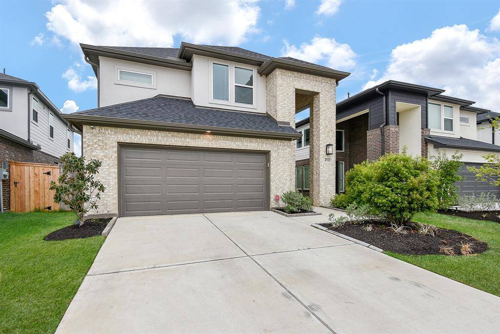 Modern two-story home with a clean, brick exterior and a spacious double garage. The driveway is expansive, and the front yard is well-maintained with fresh landscaping. Perfect for families seeking a stylish and comfortable living space.