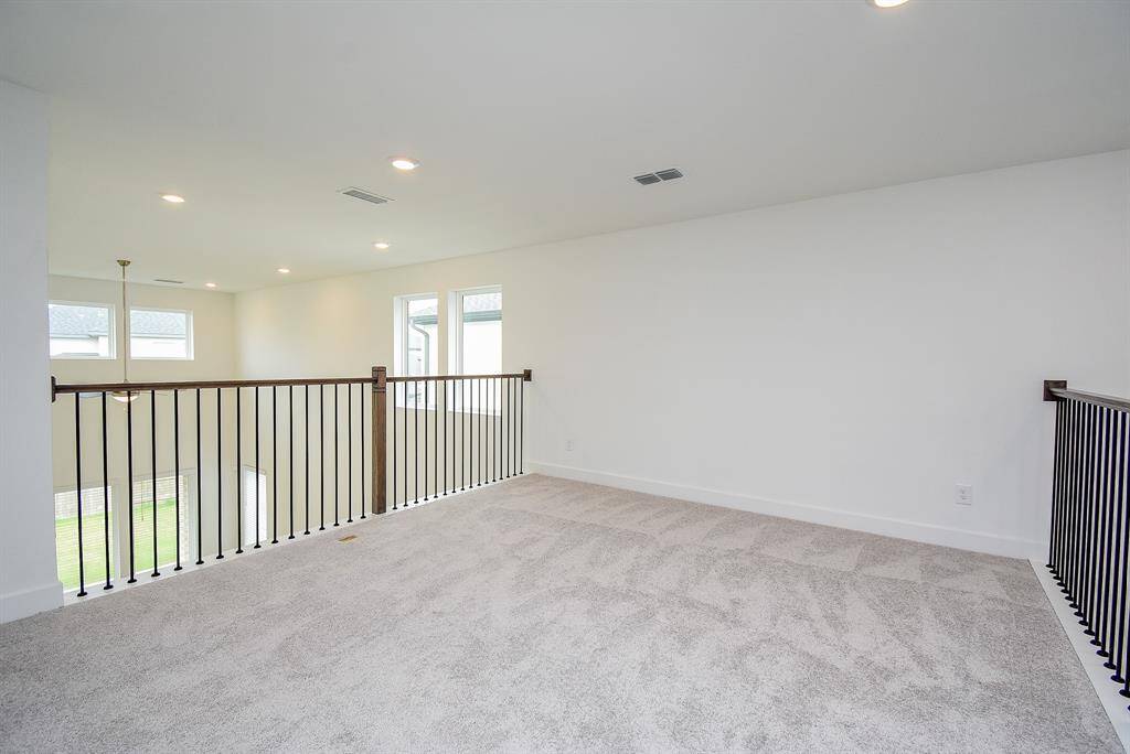 Spacious and bright loft area, perfect for a game room or entertainment space.