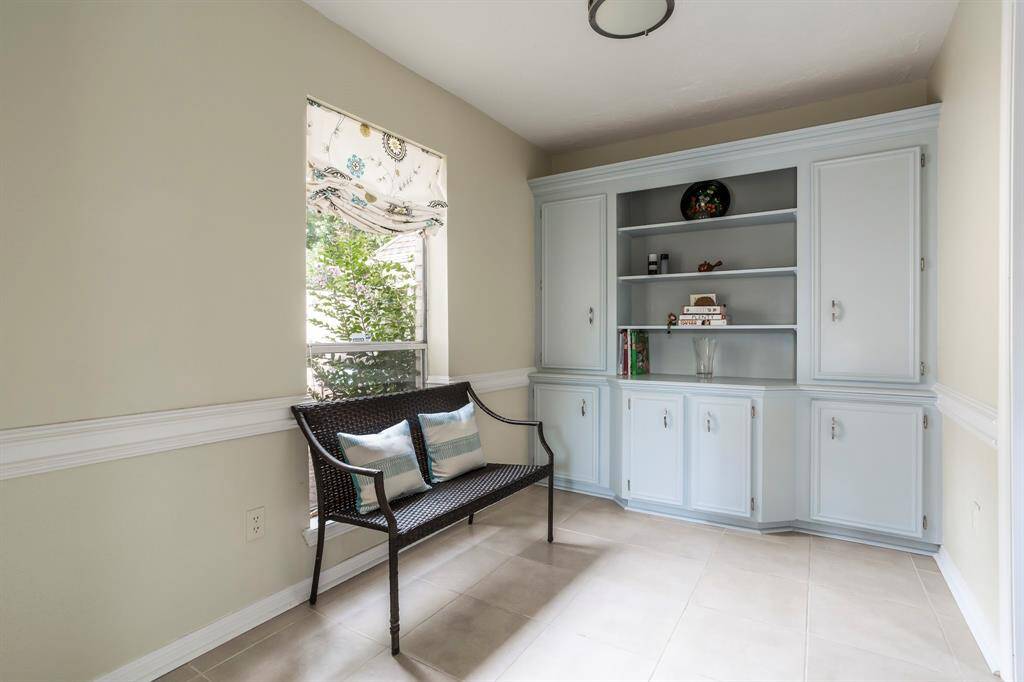 This cozy breakfast area is filled with natural light and features built-in cabinetry that offers both storage and display space. Whether you're easing into the day with a quiet morning moment or grabbing a midnight snack, this sunny nook is the perfect place to pause and recharge.