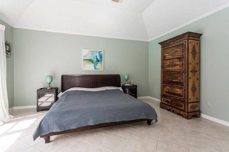 You’ll have sweet dreams in this posh owner’s retreat, featuring a soaring ceiling, two walk-in closets, and an ensuite bathroom. A wall of windows fills the space with natural light and offers peaceful views of the sparkling pool, creating the perfect place to stretch out, unwind, and catch your breath.