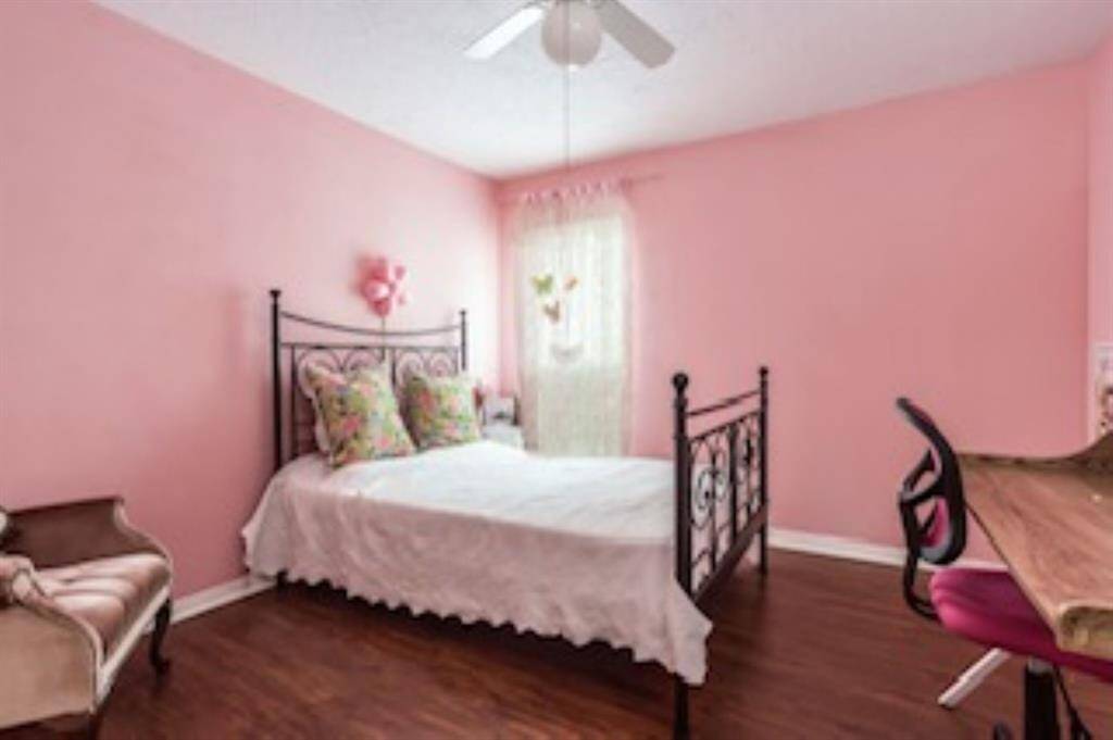 This cheerful guest bedroom offers plenty of space to relax, complete with a large closet for storage and easy access to a nearby full bathroom. It’s the perfect spot to make family and guests feel comfortable and right at home.