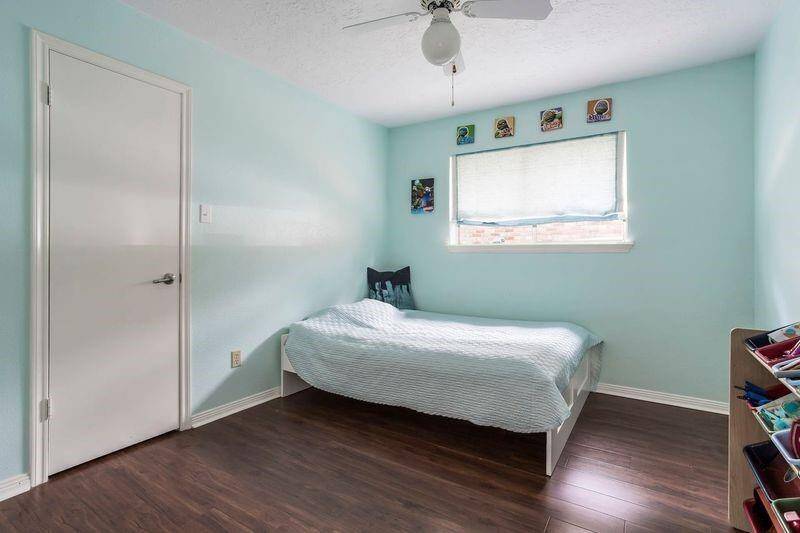 This secondary bedroom offers a peaceful retreat with soft paint tones, durable laminate flooring, and a spacious closet. Whether hosting overnight guests or setting up for everyday use, it’s a flexible space that’s ready to fit your needs.