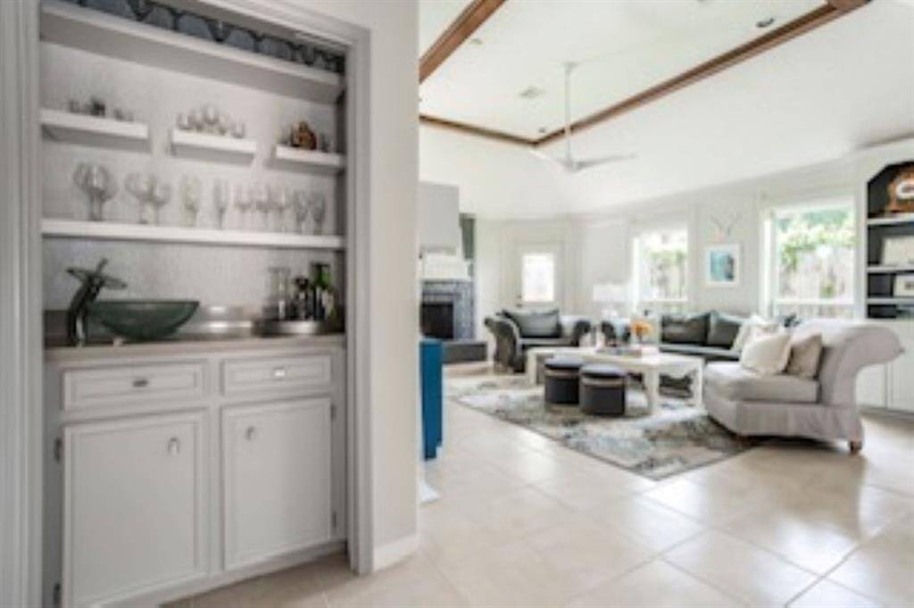 The stylish wet bar sits just off the family room, perfect for mixing drinks, displaying glassware, or setting up a snack station when guests drop by.