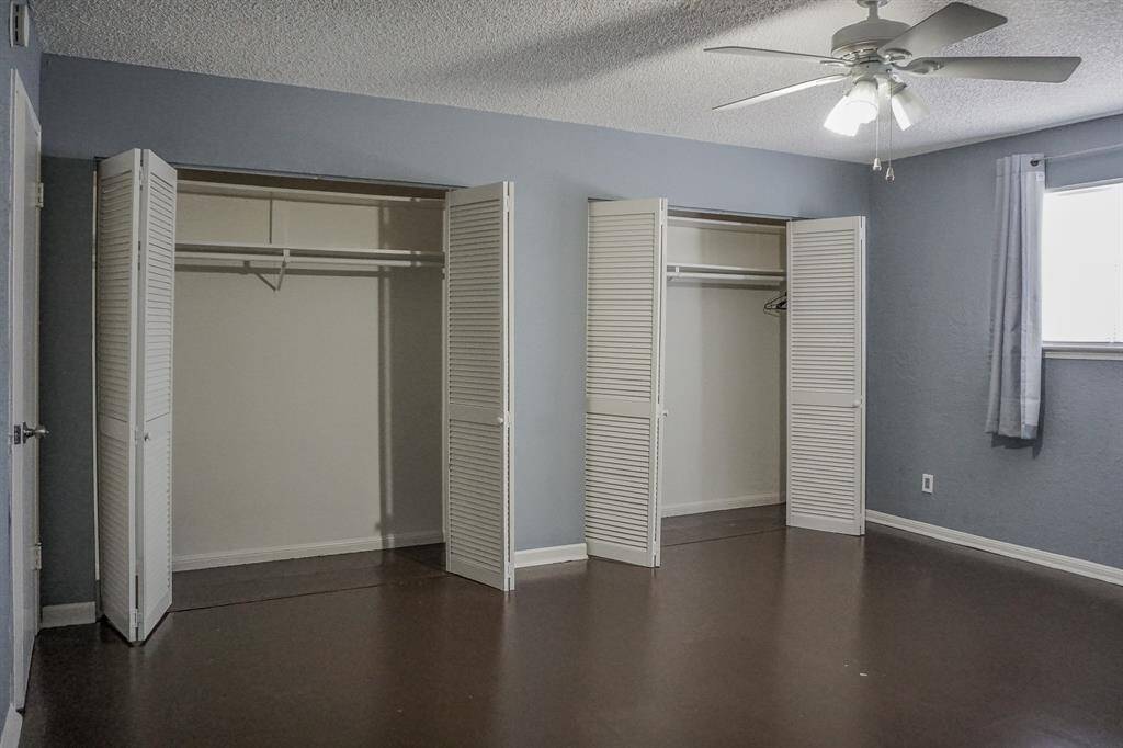 This primary bedroom is spacious and includes two closets.
