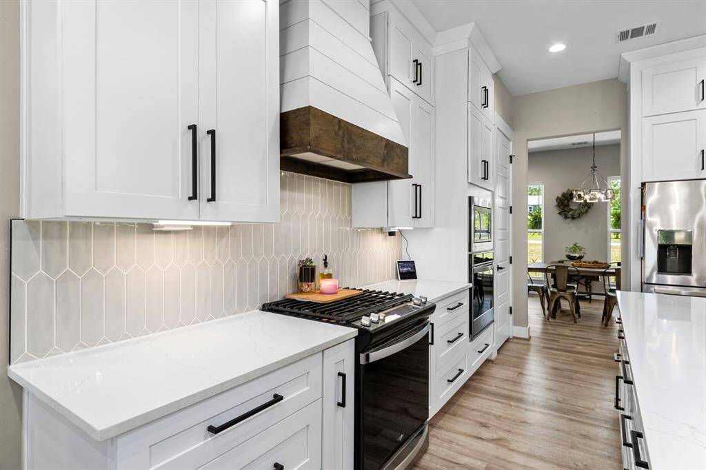 Modern tile custom work with soft colors blending well with the light colors. The under cabinet lighting is adjustable and have outlets hidden underneath.