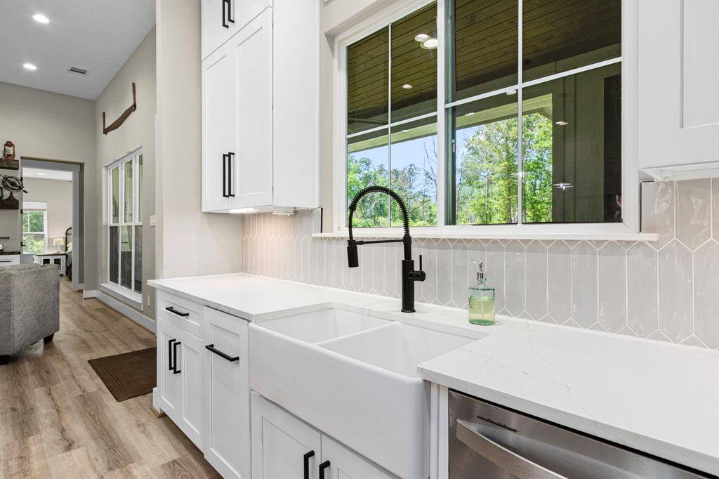 This wouldn't be complete without the popular farmhouse sink with a window out to the back view.