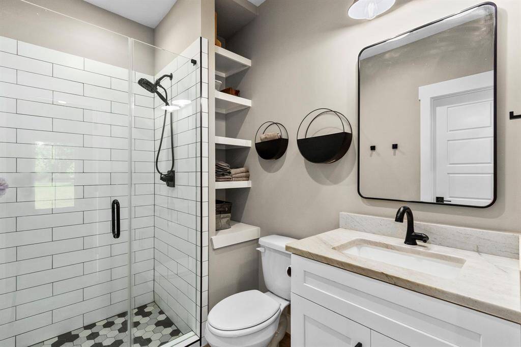 En-suite bathroom with storage and a walk in shower.