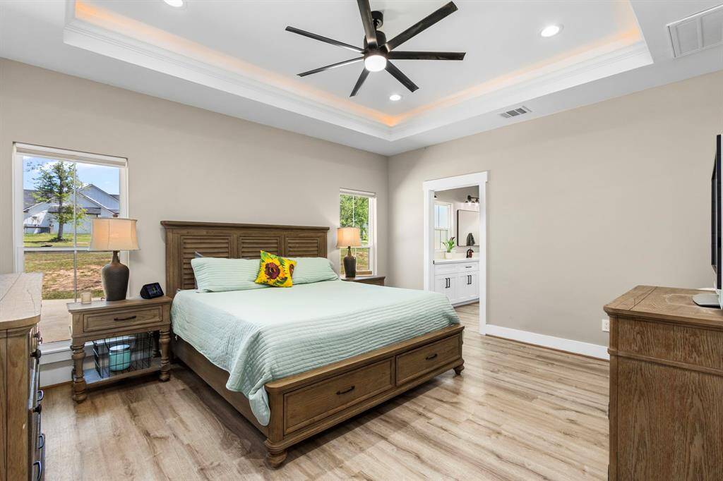 The primary bedroom set off the far side of the home is spacious, well lit, and private. Your tray ceiling even has a separate lighting feature to compliment the ambiance.