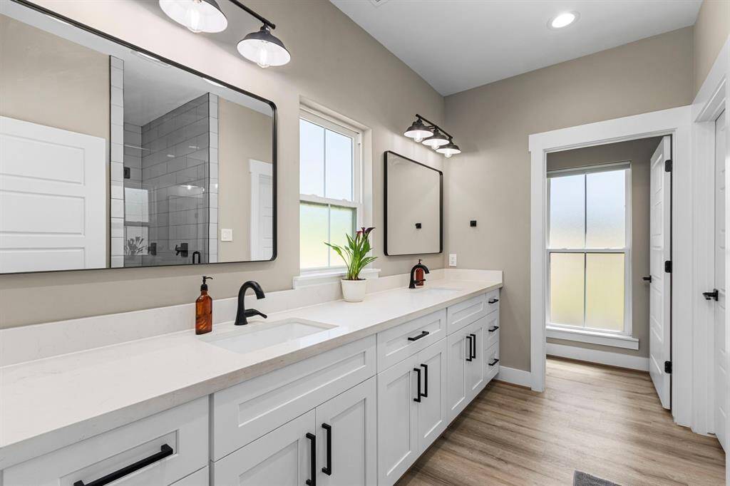 Thought the primary bedroom you have an ensuite with an oversized counter space, double sinks, and lots of natural light.