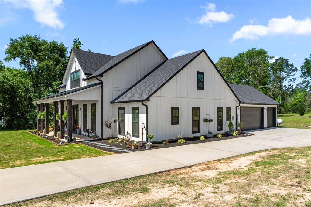 Abundant landscaping surrounding the front and side of home with a stone path to your expansive front porch.