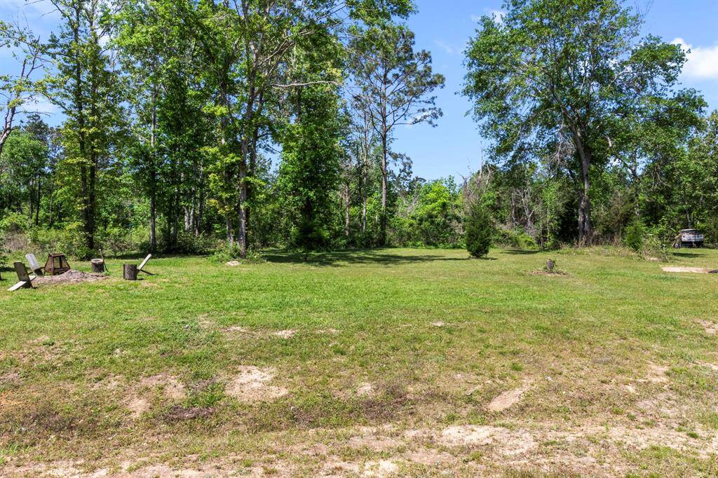 A traditional fire burning area to enjoy near the forested area. This lot goes beyond these trees and has manicured areas to walk through.