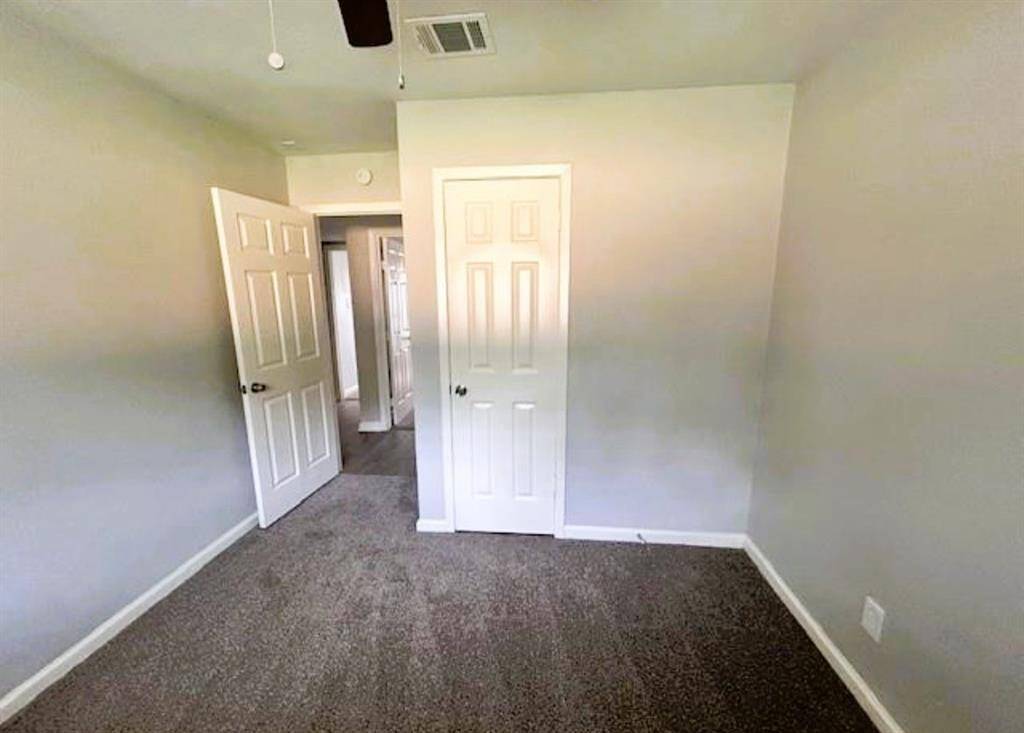 A view of one of the four bedrooms. All bedrooms have carpet