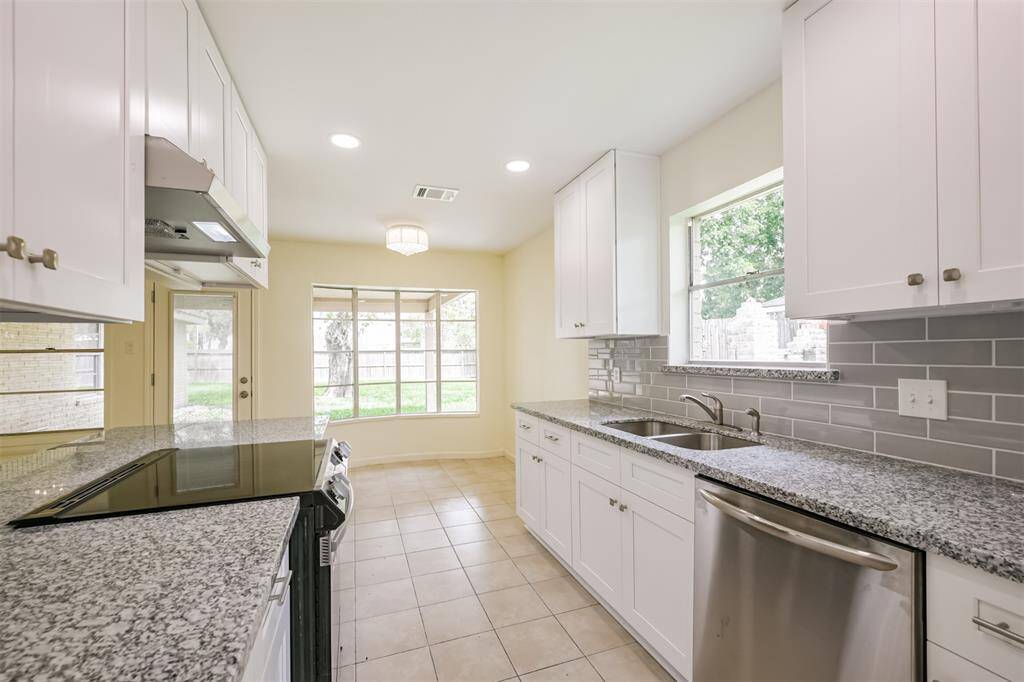 Kitchen boasts new cabinets, dishwasher and stove.