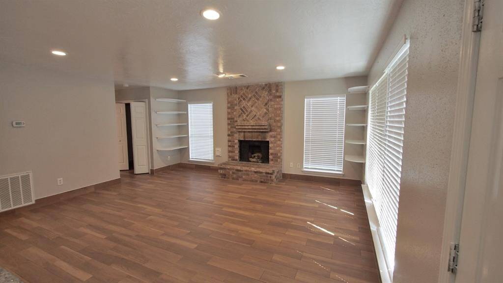 View of the Family-Room from the Kitchen showing the large wood-burning fireplace...