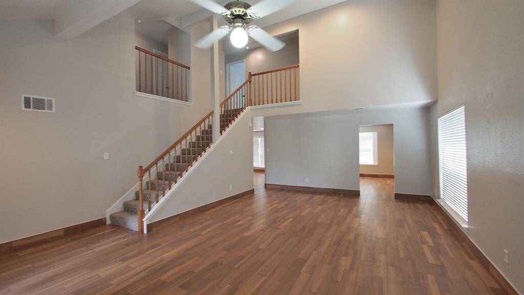 View of the Great-Room and stairs leading to the rooms & entry into the kitchen & family room