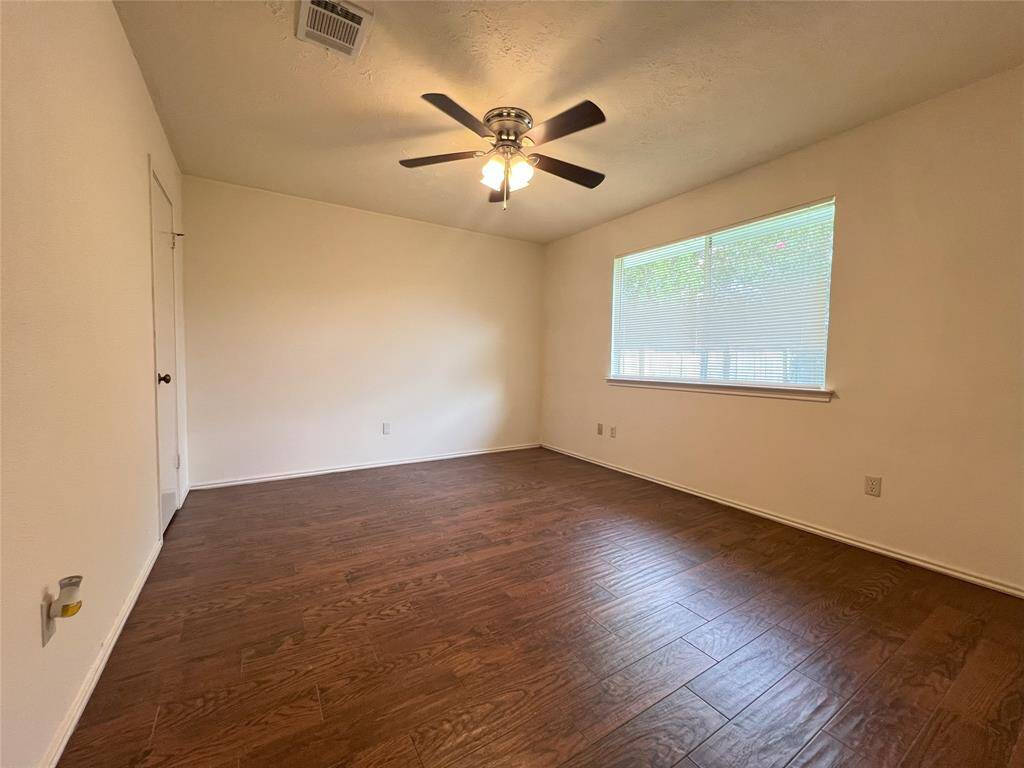 Master Bedroom with wood look tile floor