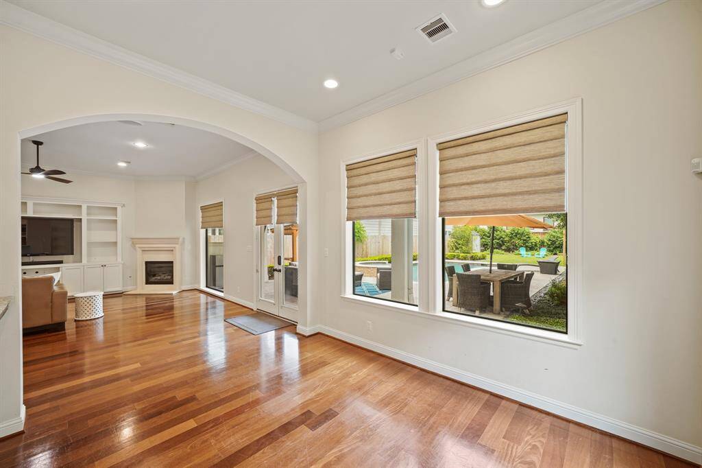 A view from the breakfast room of the family room and the many windows overlooking the backyard & pool.