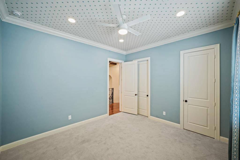 Another view of the second bedroom with the wardrobe closet and second floor corridor in the background.