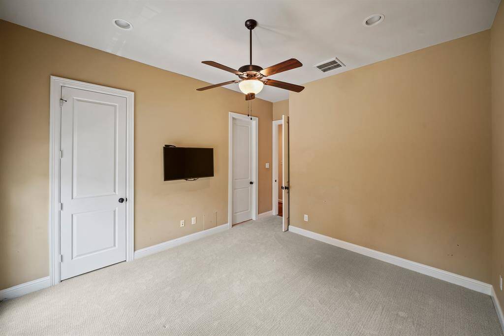 Perfect as a guest or mother-in-law suite, this fourth bedroom has access to the en-suite bath on the left. The wall mounted flat screen TV will remain with the home.