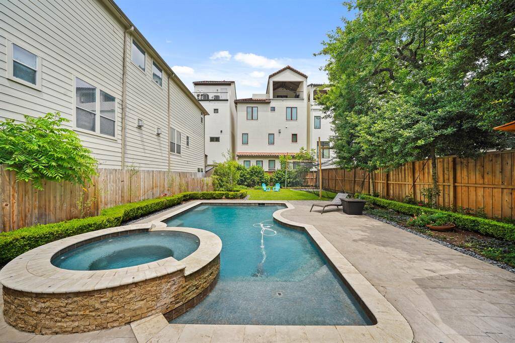 Gather family & friends for a fun day in the sun in this fabulous backyard with space for poolside lounging & dining!