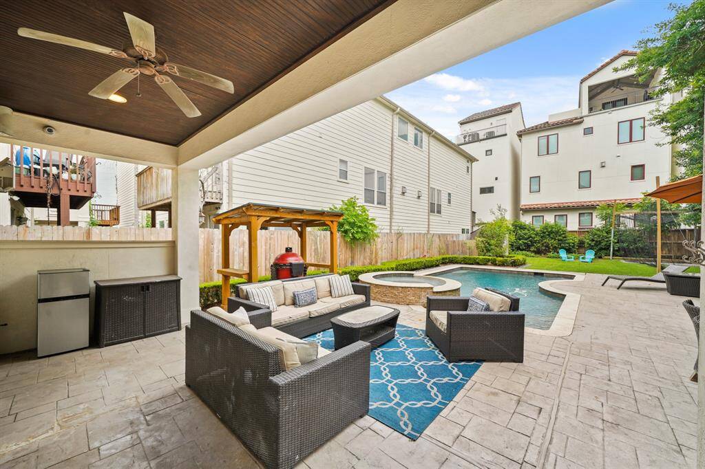 The covered patio with a wood-stained bead board ceiling, recessed lights & ceiling fan with lighting includes outdoor speakers and a gas "stub" for a natural gas grill.