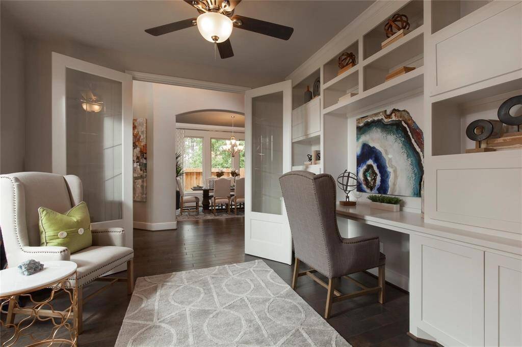 The private study is enclosed by classic double French doors and features a custom built-in shelves and a spacious desk create a functional and sophisticated workspace.