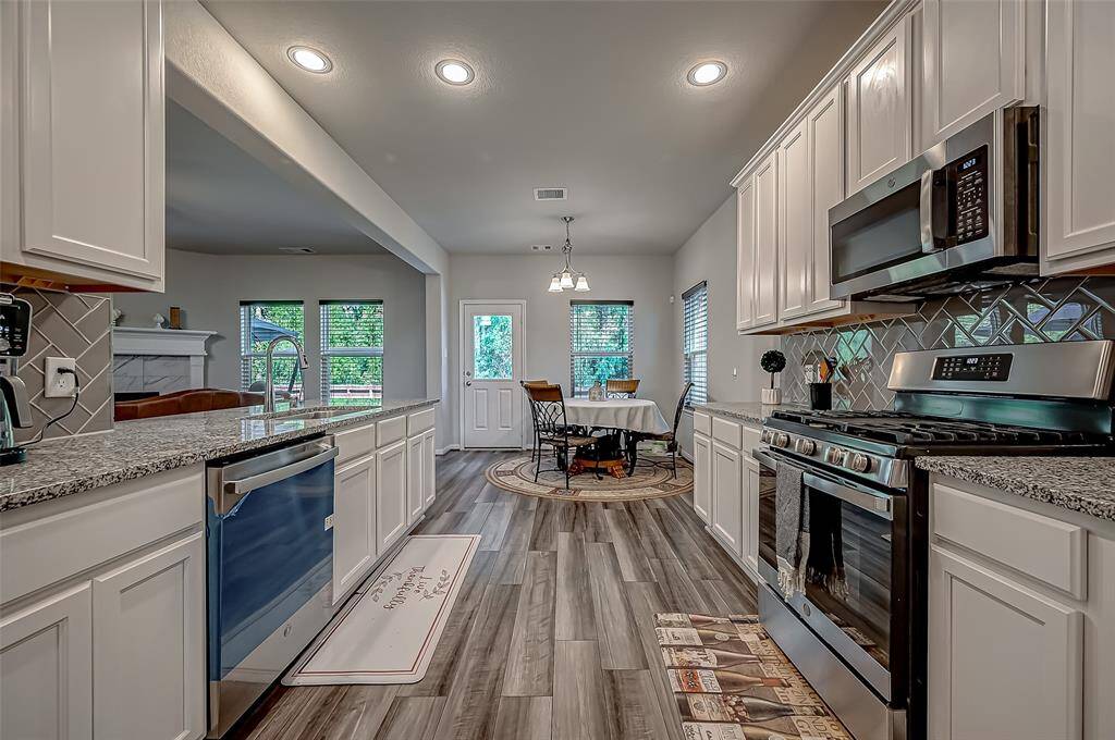 Surrounding the kitchen, generous cabinetry offers ample storage for cookware, utensils, and pantry items, ensuring the space stays organized and clutter-free.
