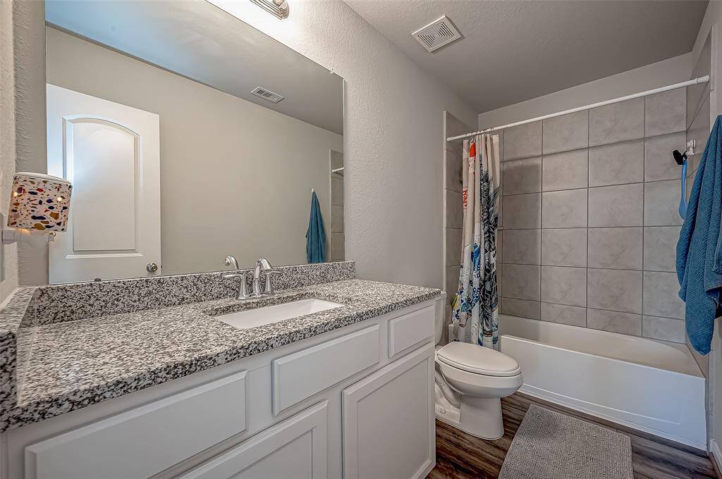 The secondary bathroom features granite counter tops with a bath/shower combo. Ready for your daily needs.