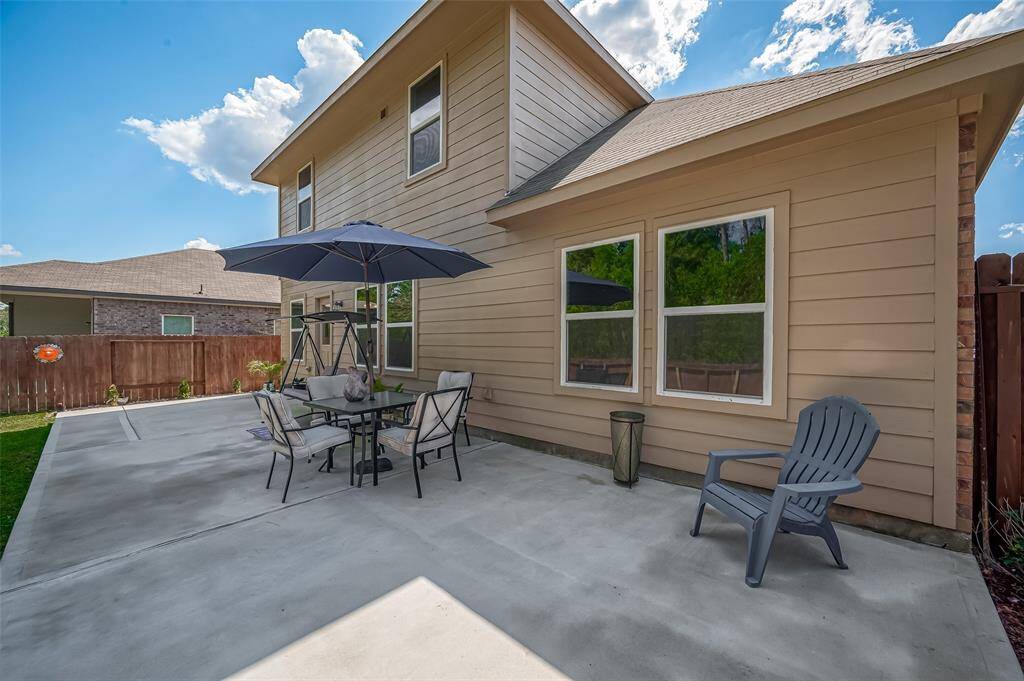 Step into the backyard and be greeted by a spacious and inviting patio area. It's perfect for outdoor entertainment and relaxation.