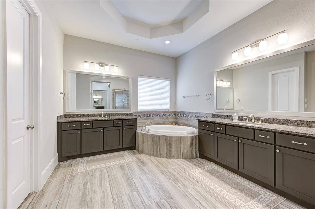 Super spacious primary bath displaying the his and hers