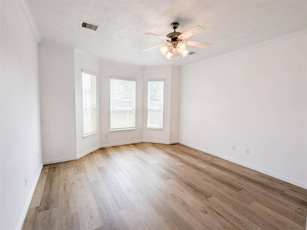 Master bedroom with bay windows and fans
