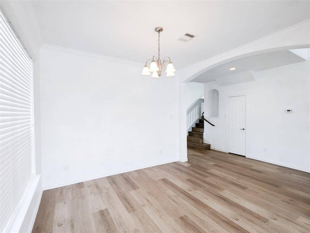 formal dining room with chandelier and large windows
