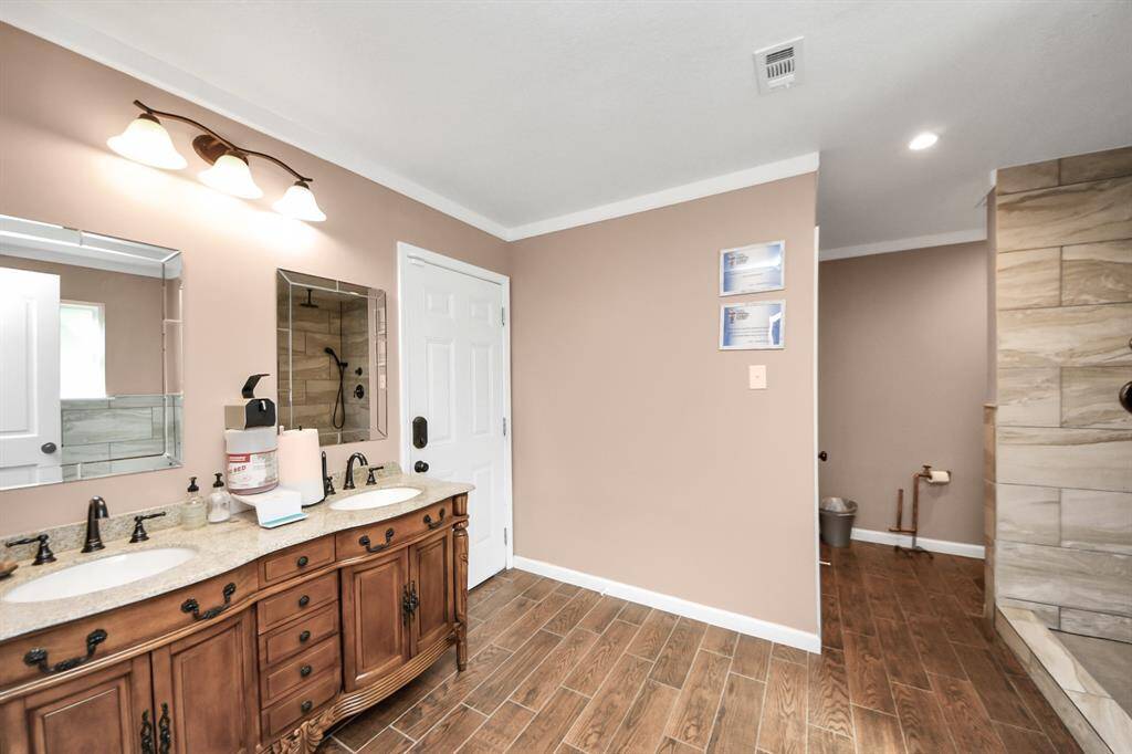 The full bath with granite vanity and large shower.