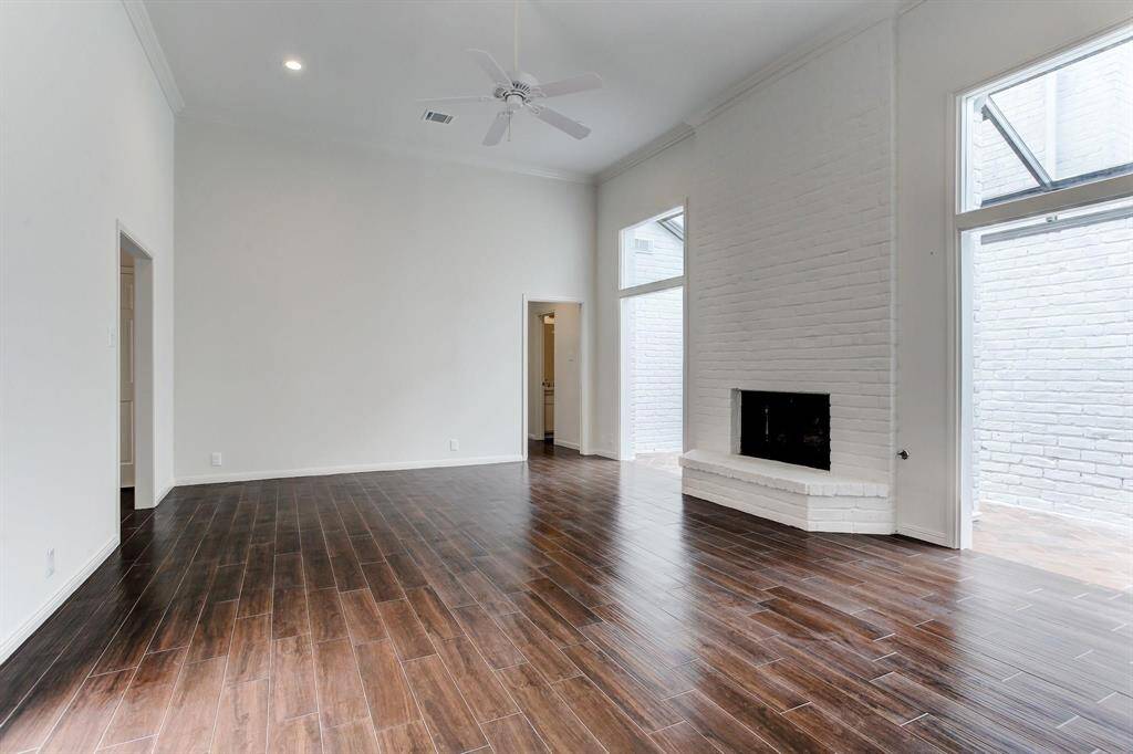 Another angle of this great living room featuring a gas log fireplace with brick surround to ceiling.